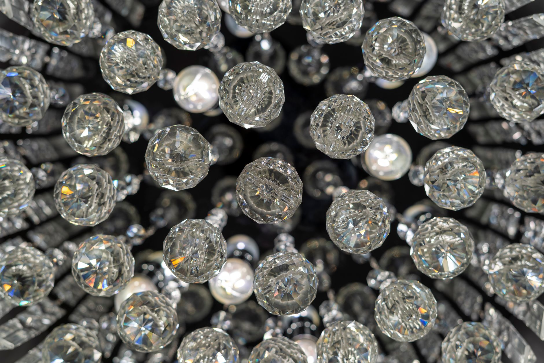 Close-up view of a dazzling crystal chandelier, radiating luxury and elegance.
