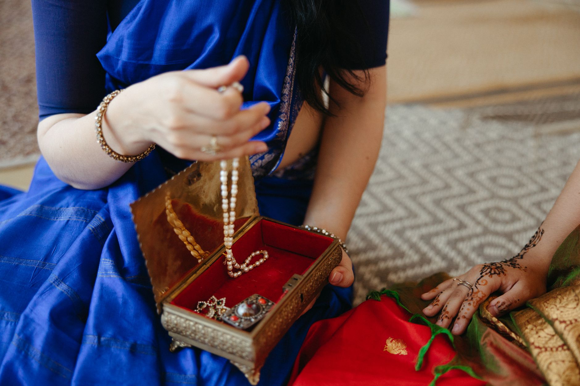 Close-up view of traditional jewelry and hand adornments in an elegant setting.