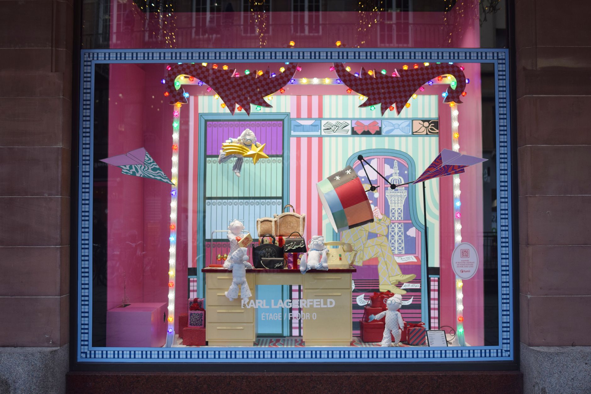 Festive holiday window display in Strasbourg, France featuring a colorful and creative design.