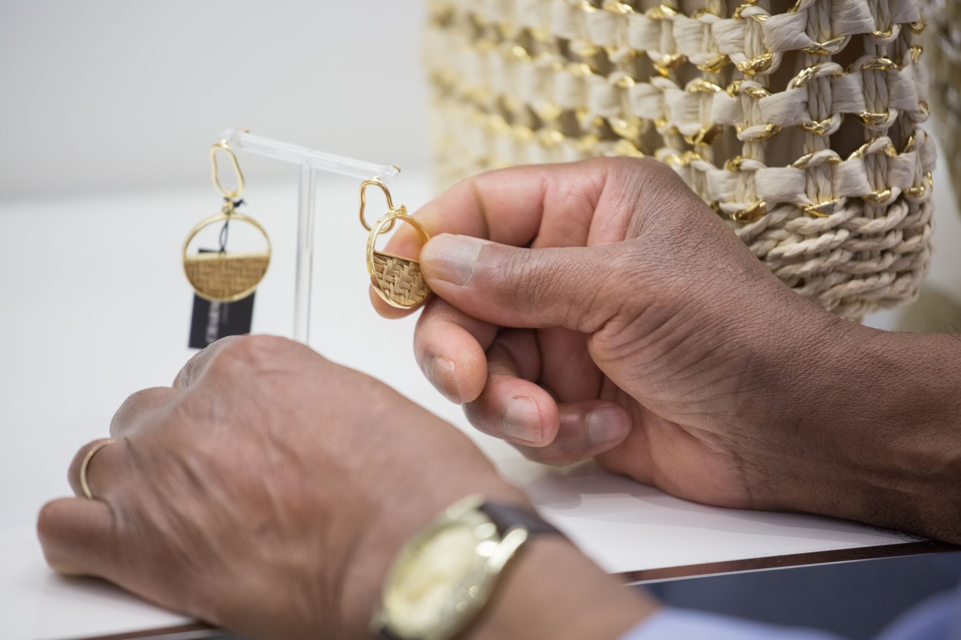 Close-up of hands showcasing elegant handmade earrings in Portugal.
