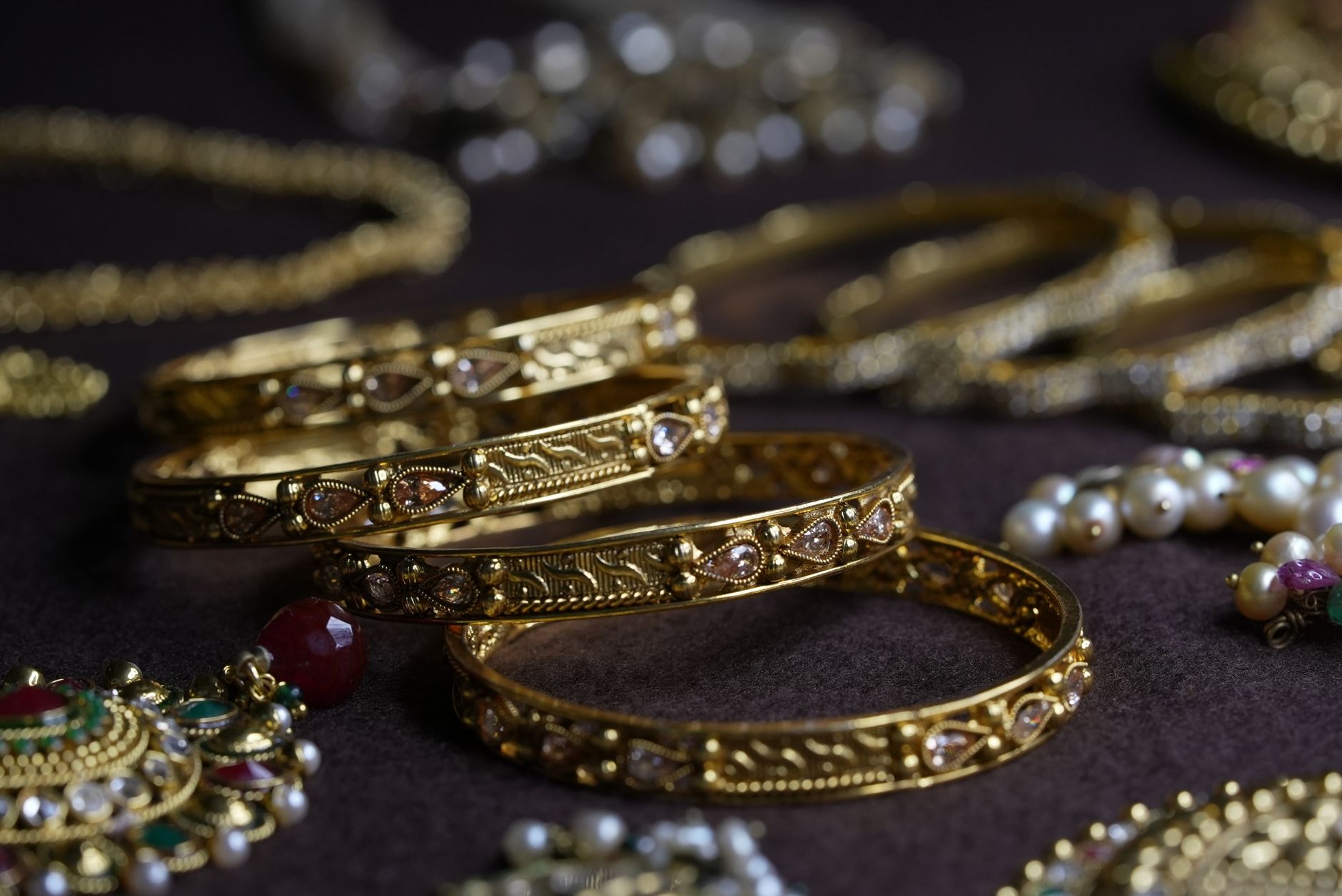 Close-up of intricate gold bangles and jewelry pieces showcasing luxurious design.