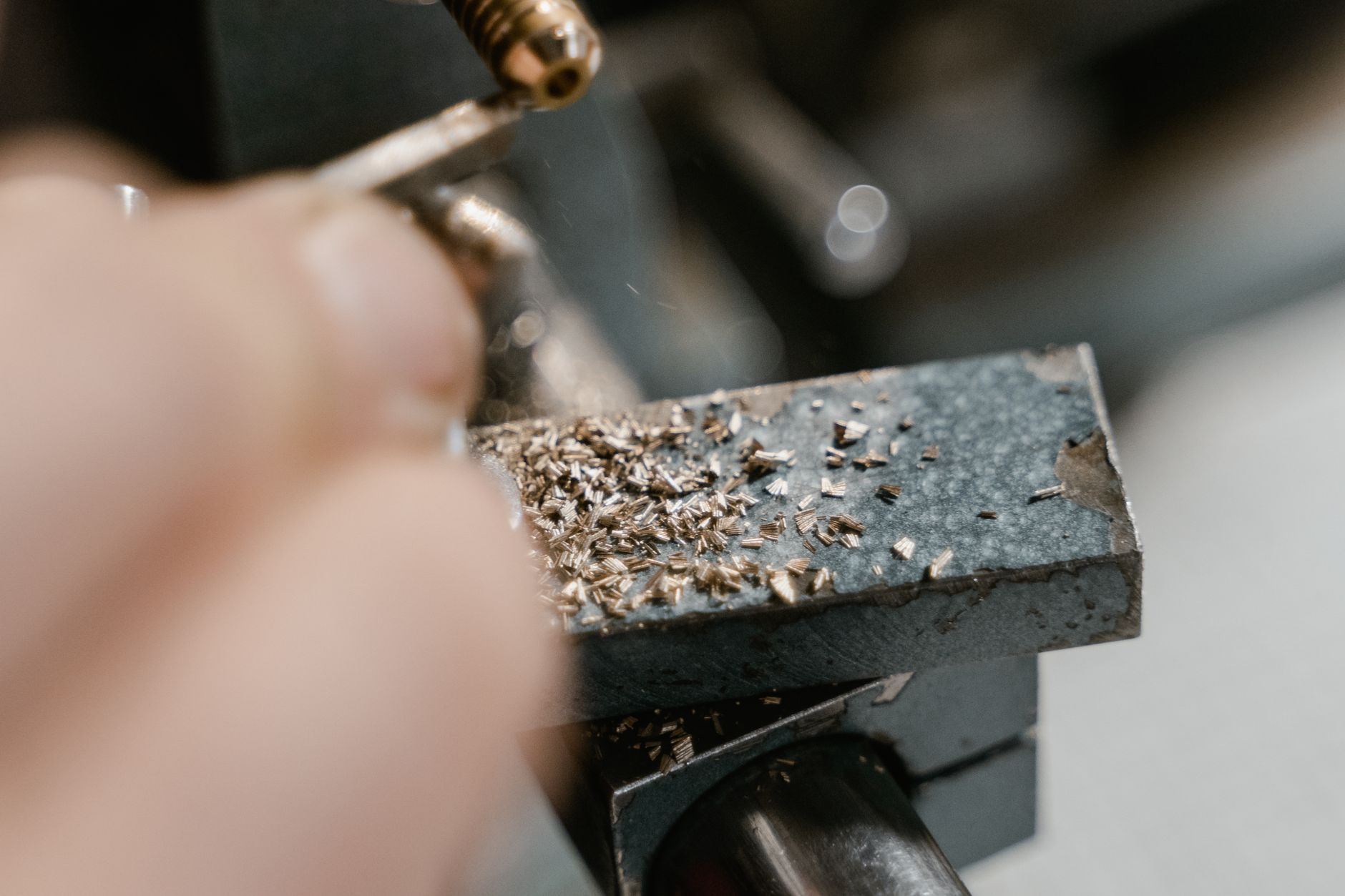 Detailed view of metal machining with drill and metal shavings, showcasing precision work.