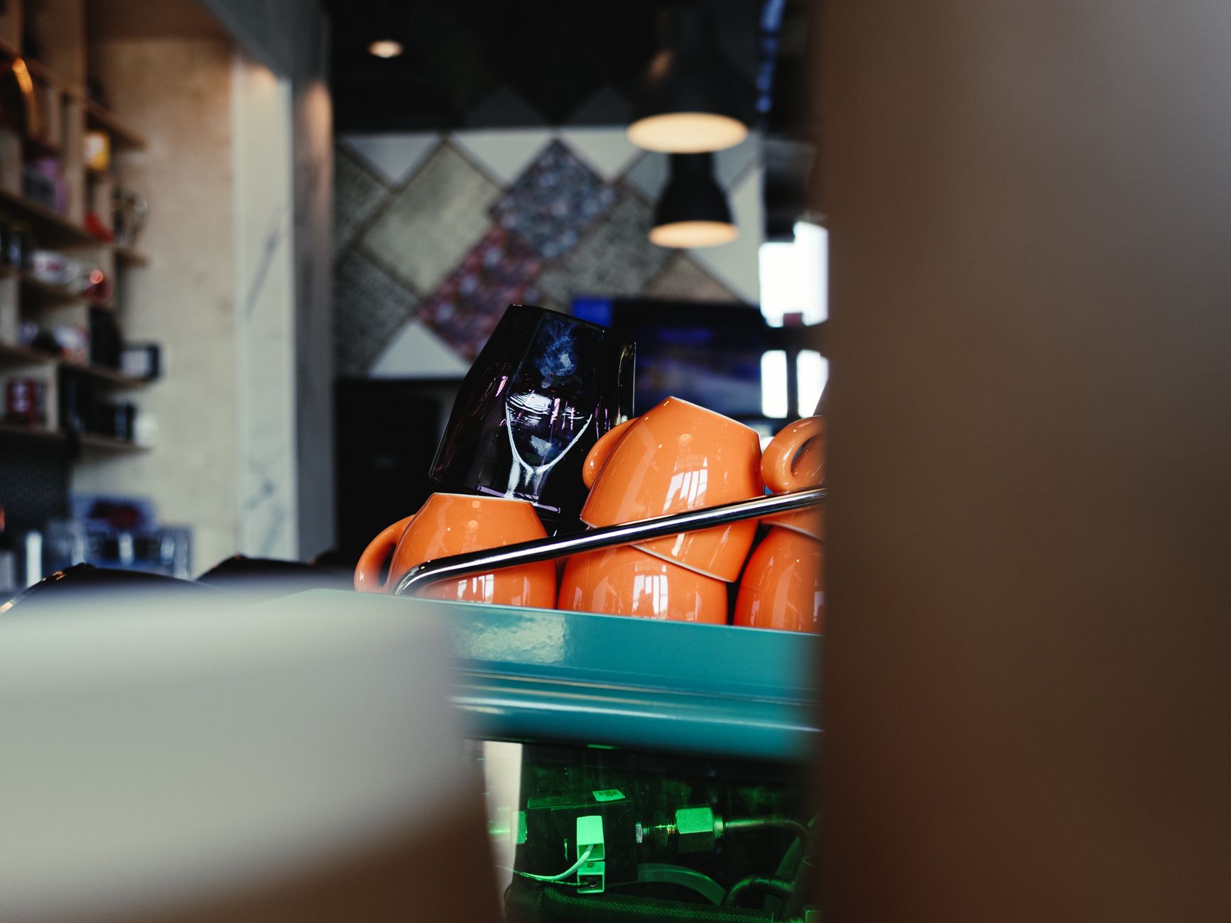 Orange cups stacked on a counter in a trendy Houston coffee shop setting.