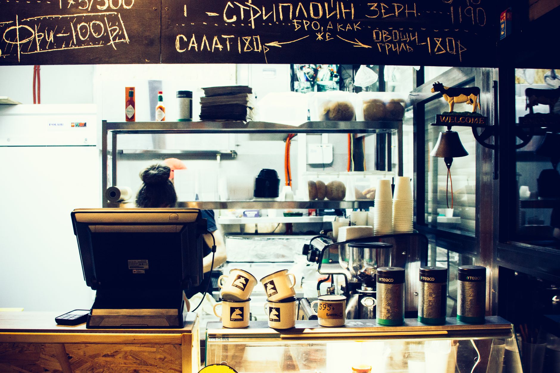 A cozy restaurant counter with chalkboard menu and cups, ideal for stock photography.