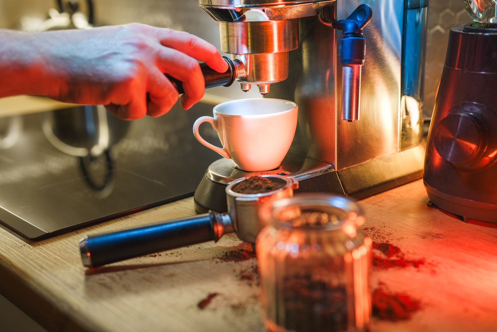 A barista uses an espresso machine to brew a fresh cup of coffee in a cozy café setting.