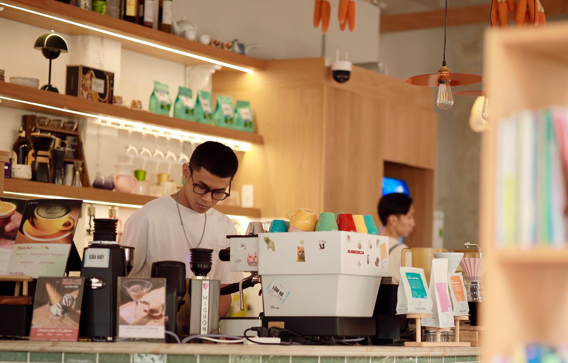 Barista working diligently in a cozy and modern coffee shop setting.