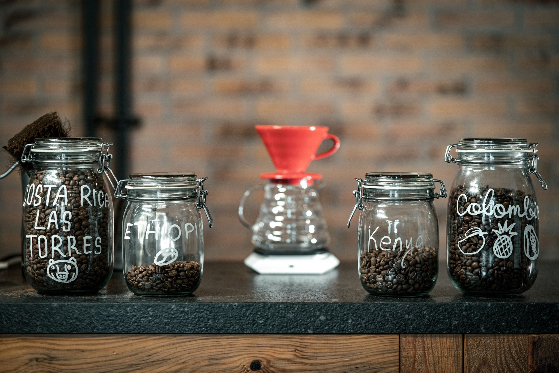 Artisan coffee jars from various origins in a boutique cafe setting in Bursa, Türkiye.