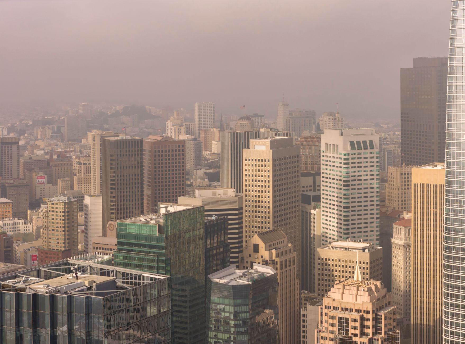 Aerial view of San Francisco skyscrapers enveloped in fog, highlighting the city's urban architecture.