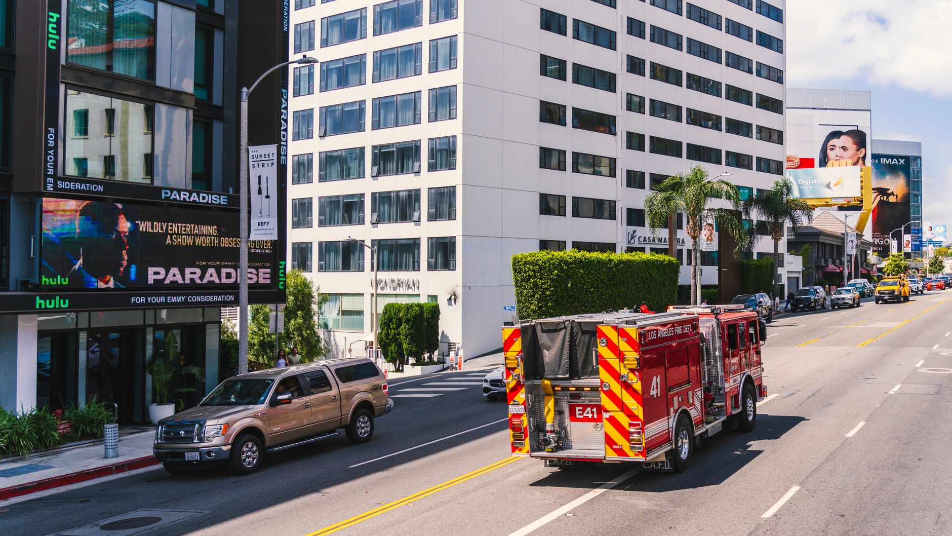 Los Angeles fire truck cruising down the famous Sunset Strip in daylight.