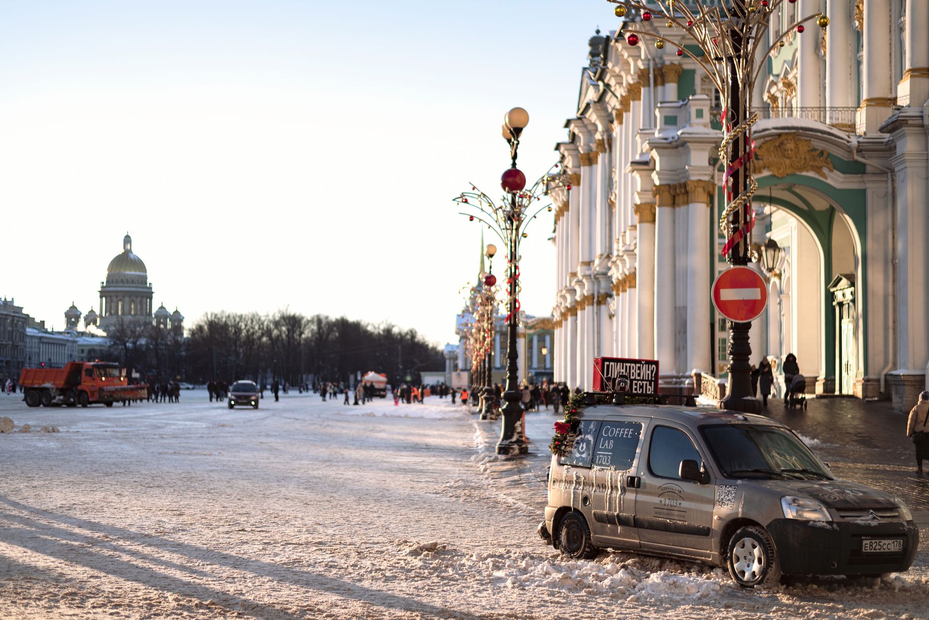 A winter day at Palace Square, Saint Petersburg, with the Hermitage and St. Isaac's Cathedral in the background.
