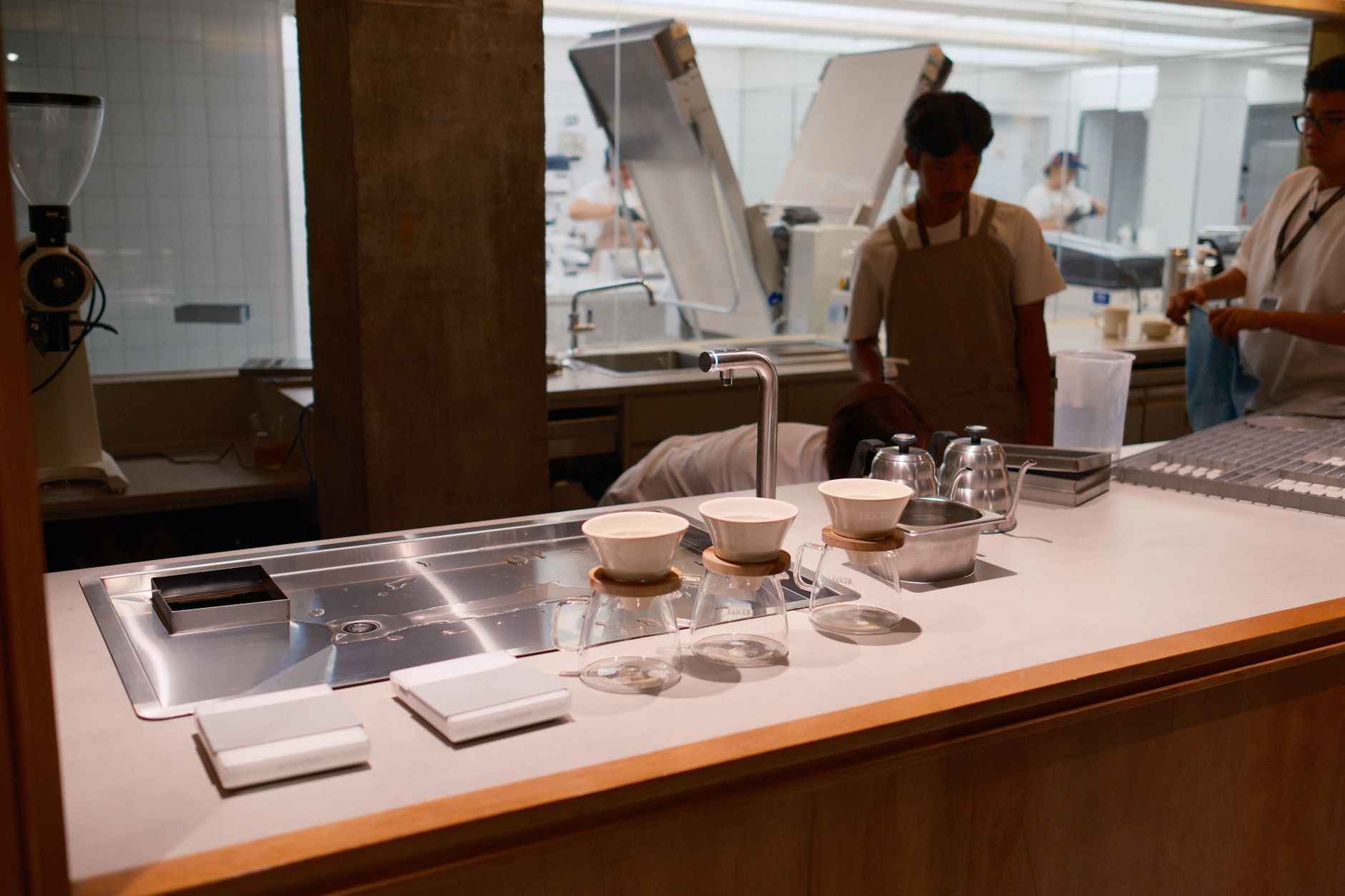A sleek coffee brewing station with baristas in a modern Jakarta café. Perfect for café and coffee-themed presentations.
