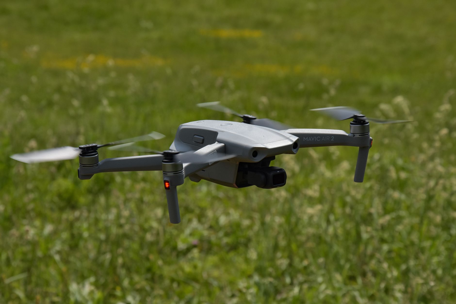 Close-up of a drone hovering outdoors in a grassy field in Virginia, showcasing modern technology in nature.
