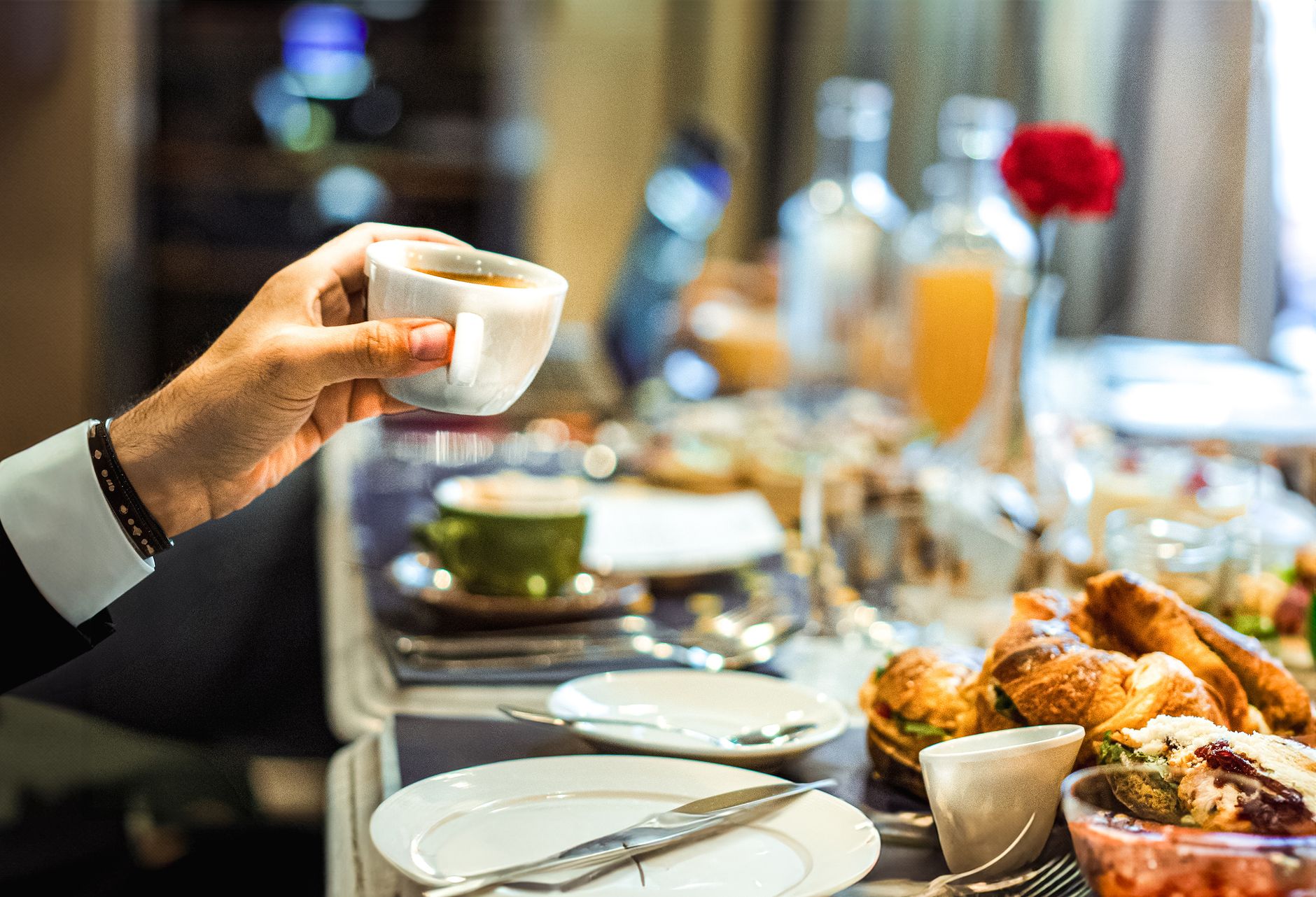 A stylish breakfast setup featuring a cappuccino and croissants on a dining table.