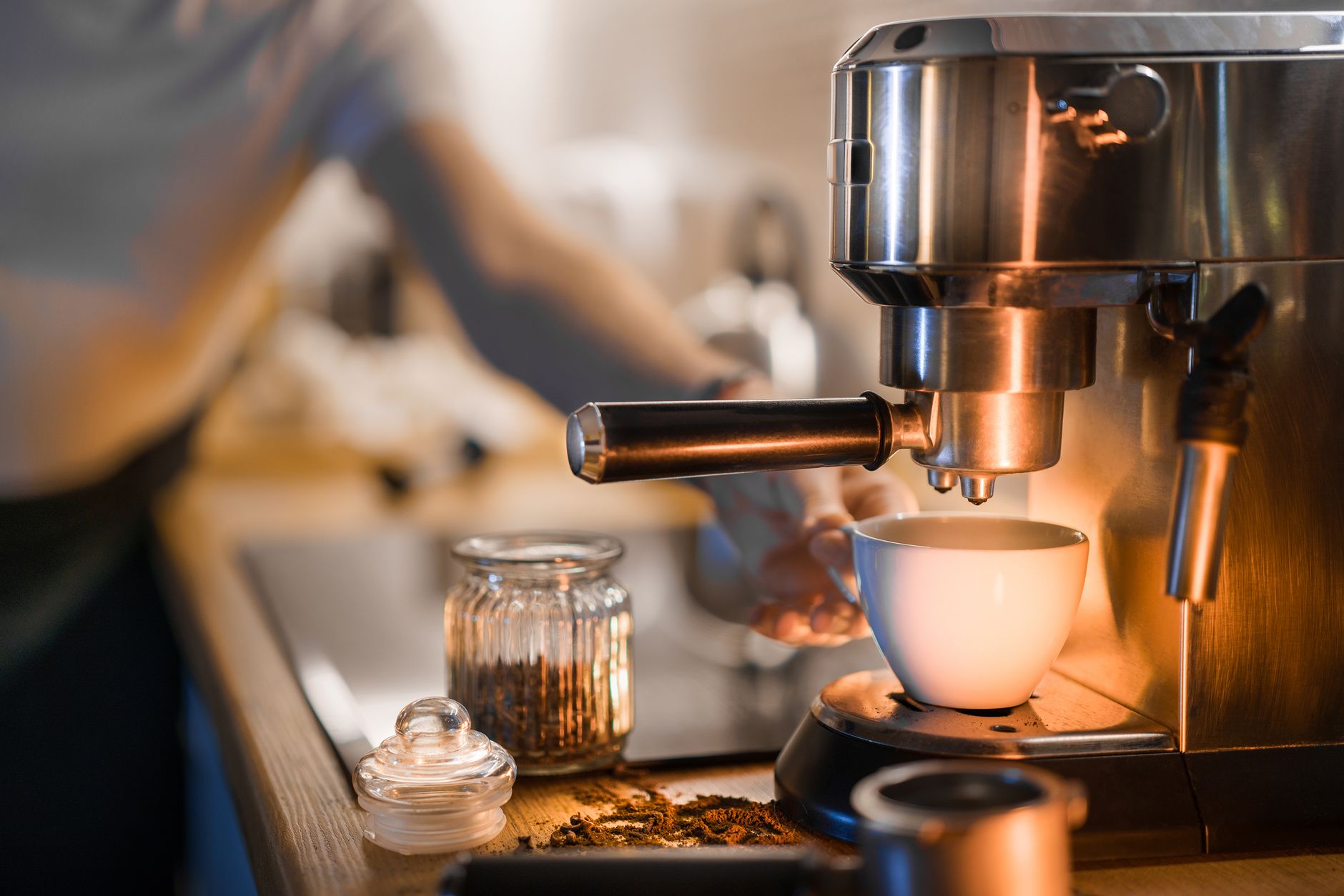 A barista prepares fresh espresso in a cozy café setting, perfect morning coffee vibe.