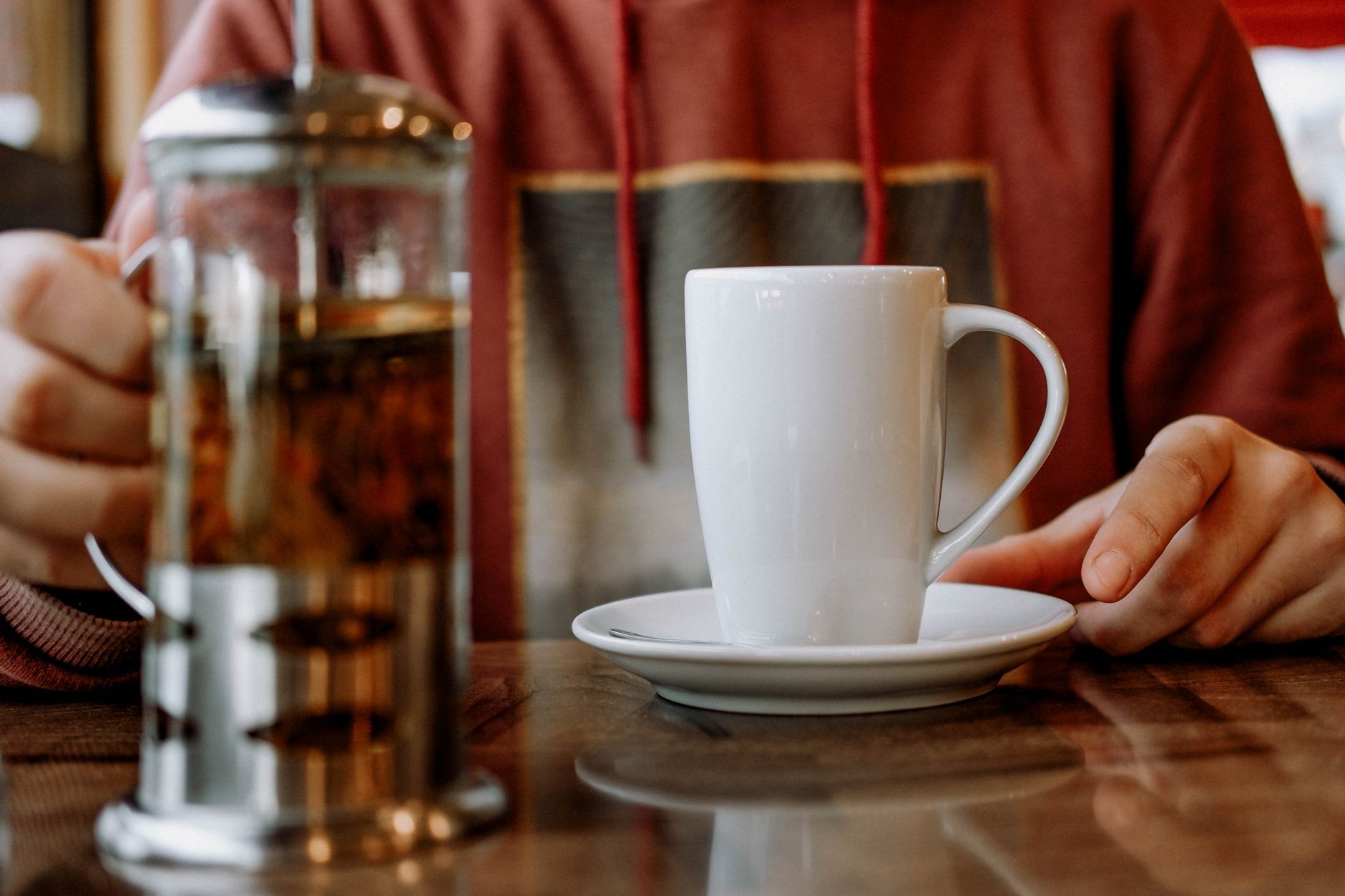 A cozy indoor setting with a mug and French press, perfect for enjoying a warm beverage.