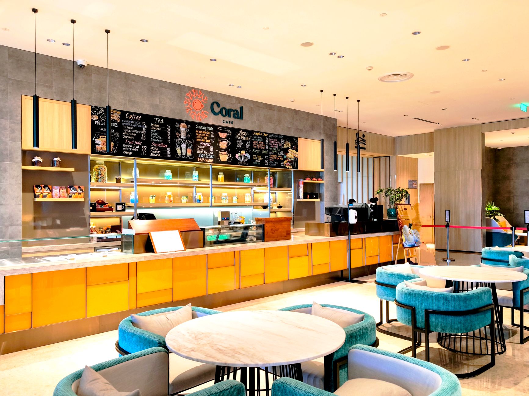 Bright and modern cafe interior with blue seating and a sleek counter.