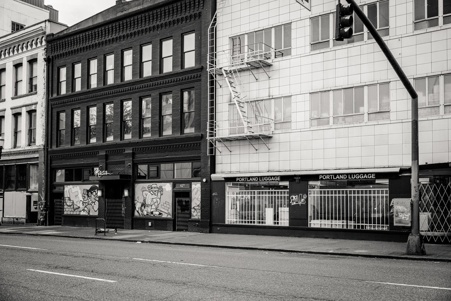 Black and white image of downtown Portland architecture with Portland Luggage store.