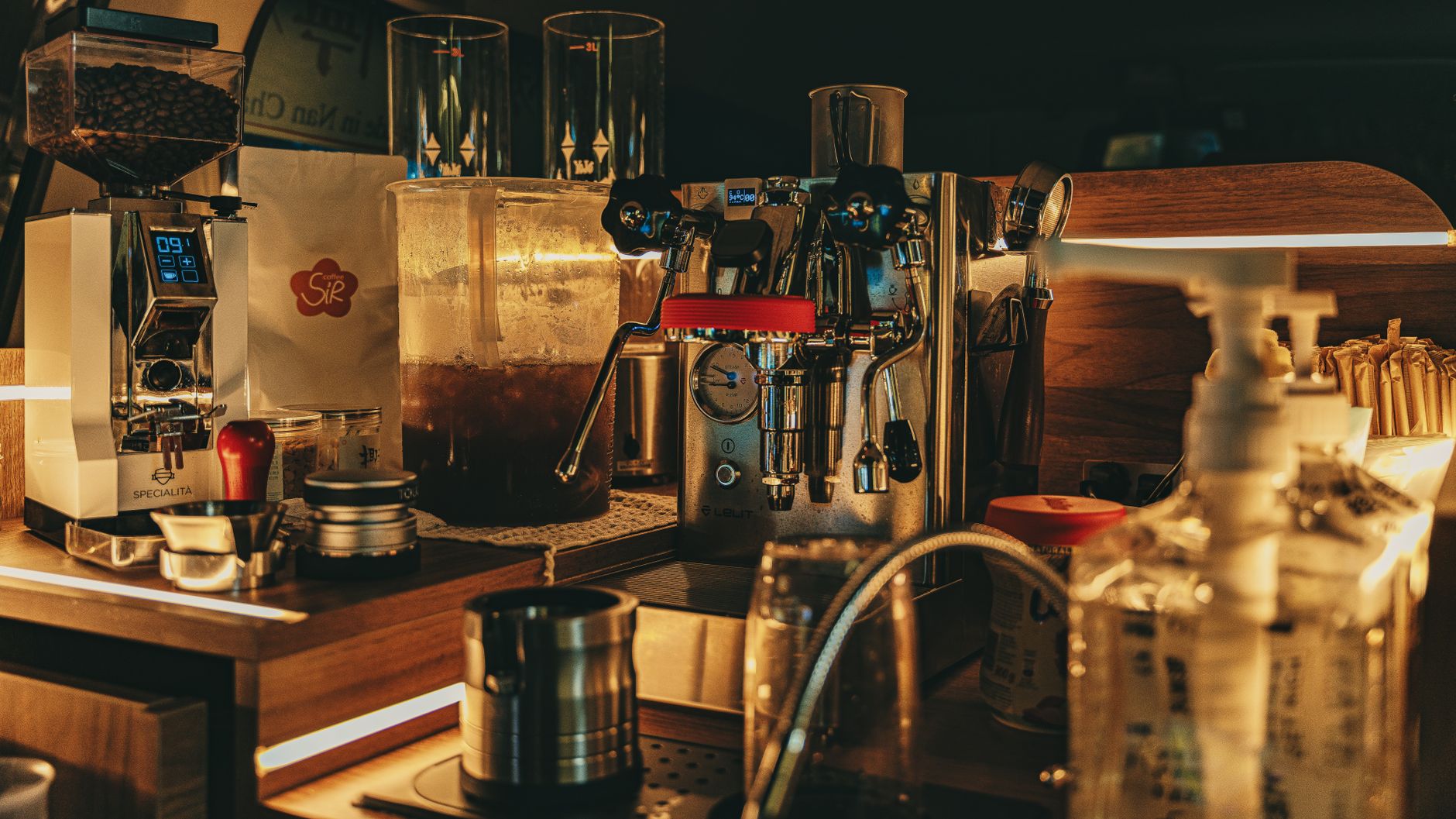A cozy café counter featuring a modern espresso machine and coffee accessories.