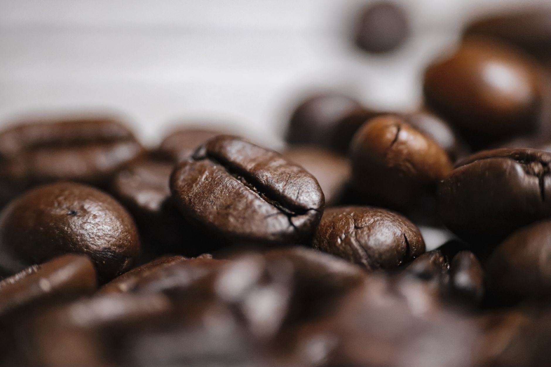 Detailed close-up of rich, aromatic roasted coffee beans showcasing texture and quality.