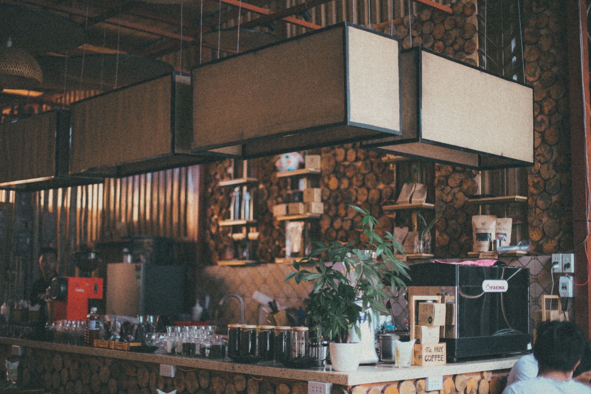 Warm and inviting rustic coffee shop interior with unique lighting and decor elements.