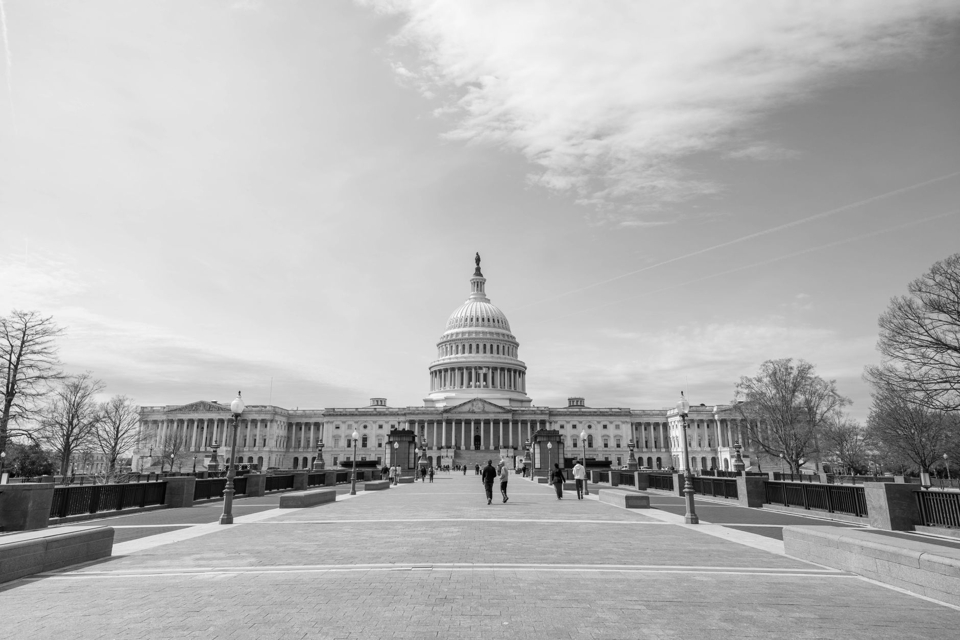 A black and white photo of the US Capitol in Washington, D.C. showcasing its architectural grandeur.