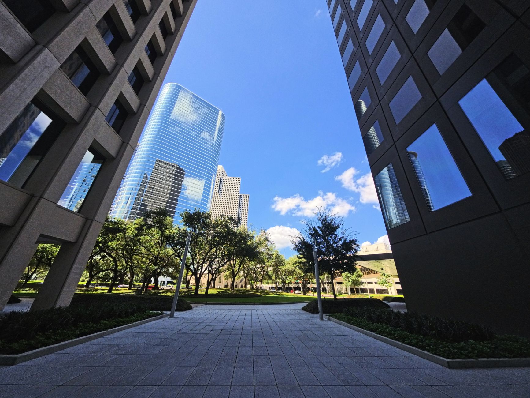 Modern skyscrapers framing the vibrant Houston skyline under a bright blue sky.