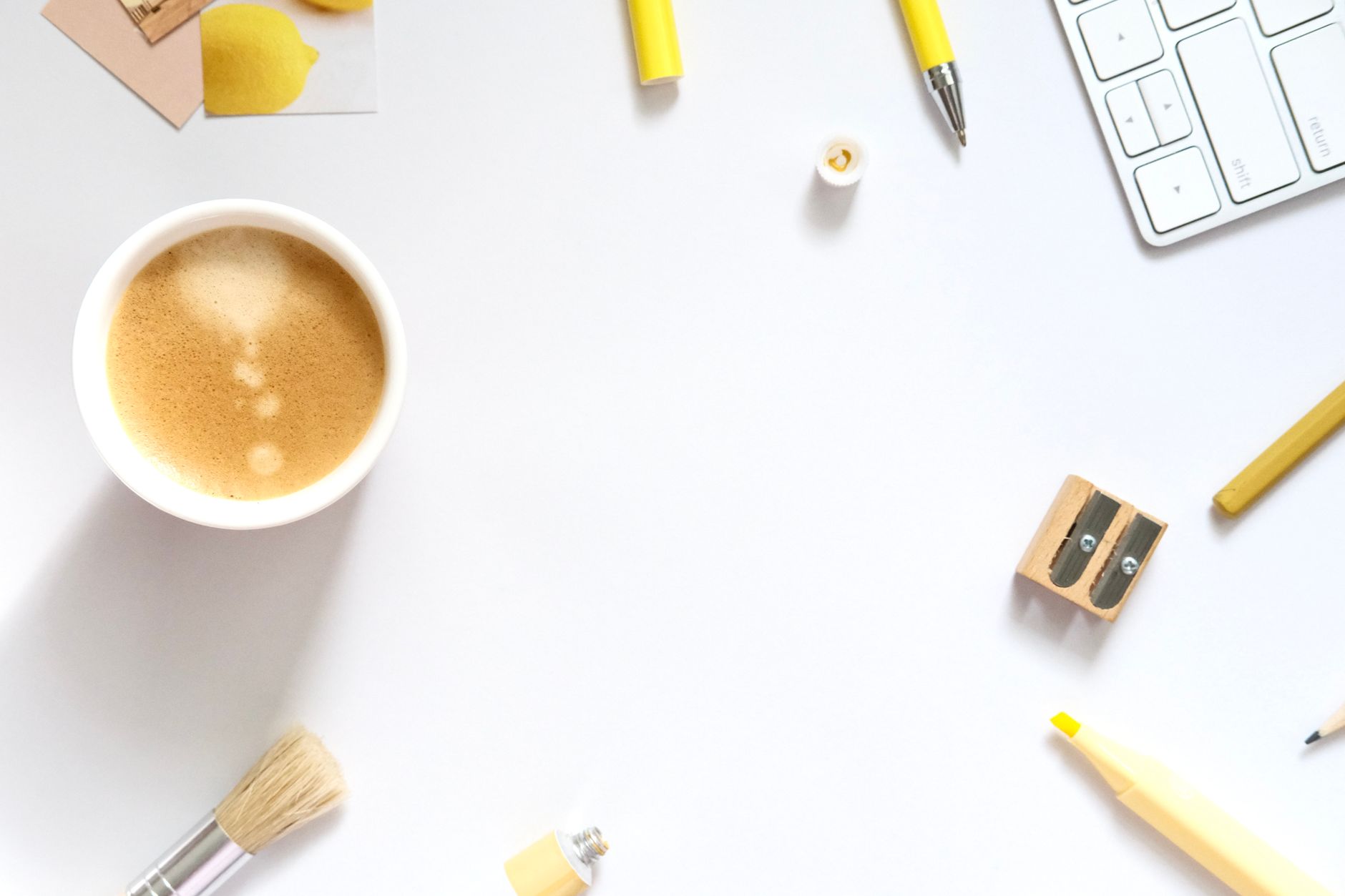 A clean, organized workspace featuring coffee, markers, and stationery in a minimalist style.