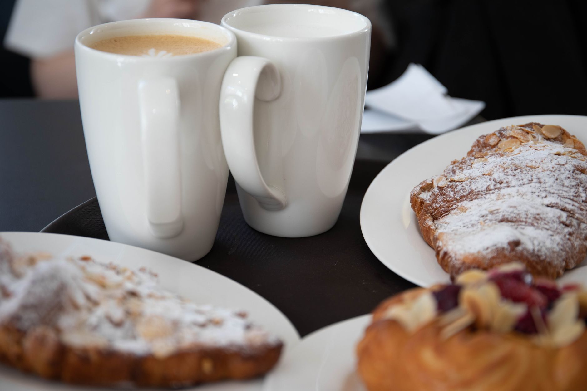 Delicious coffee and croissants served on a cozy cafe table, perfect for breakfast indulgence.