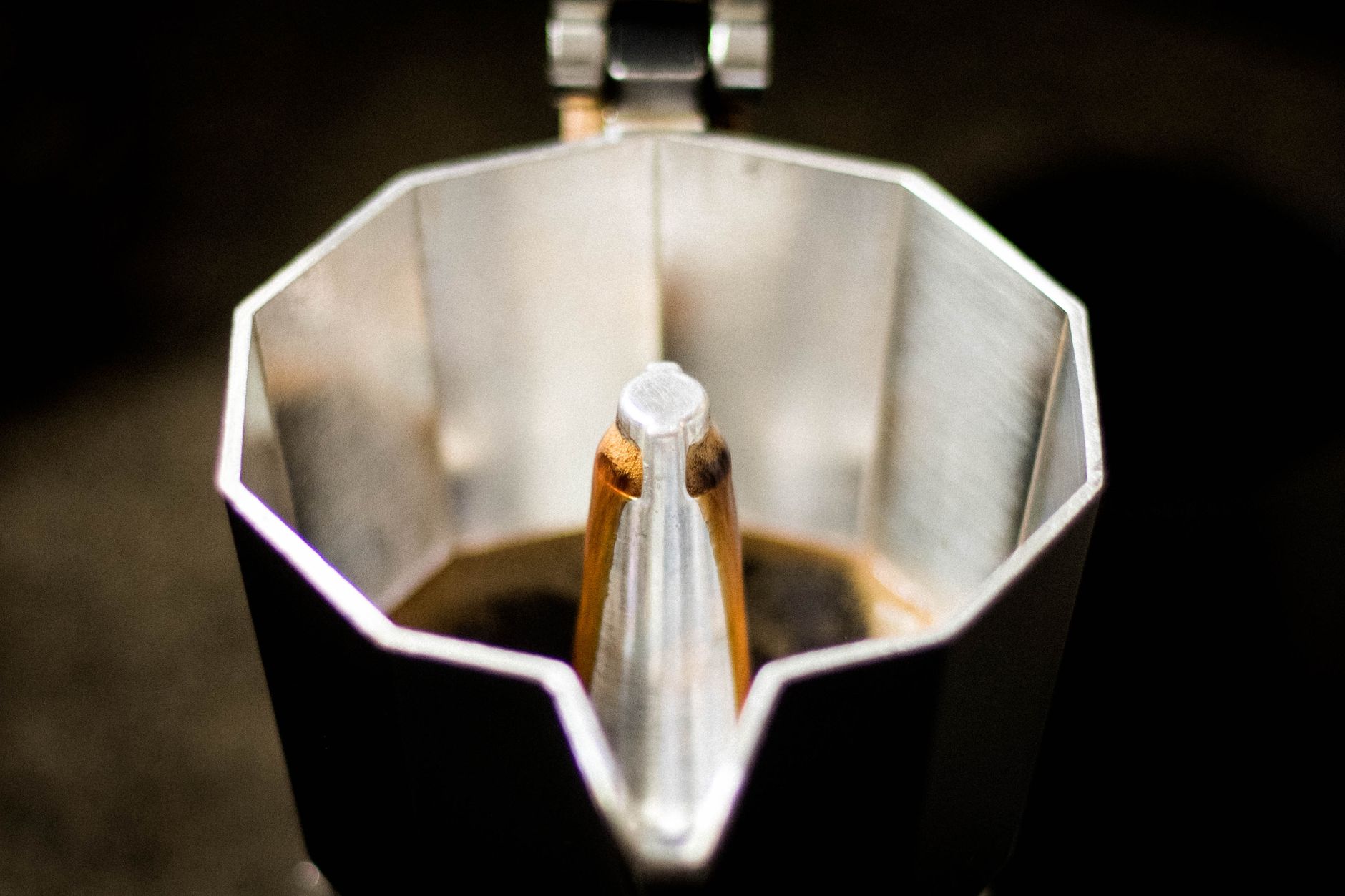 Detailed view of coffee brewing inside a classic moka pot. Perfect for caffeine lovers.