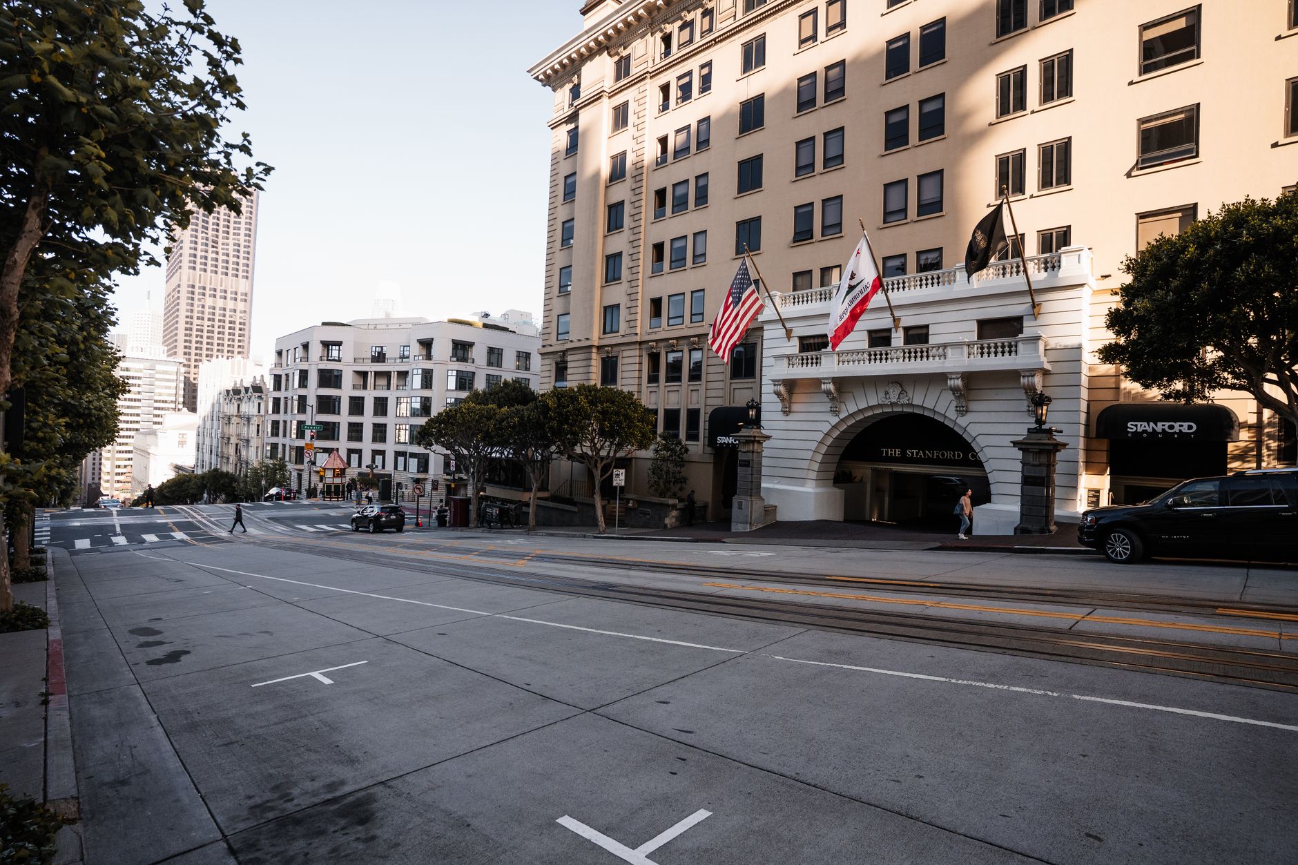 Streetscape of San Francisco featuring the Stanford Court Hotel and city architecture.