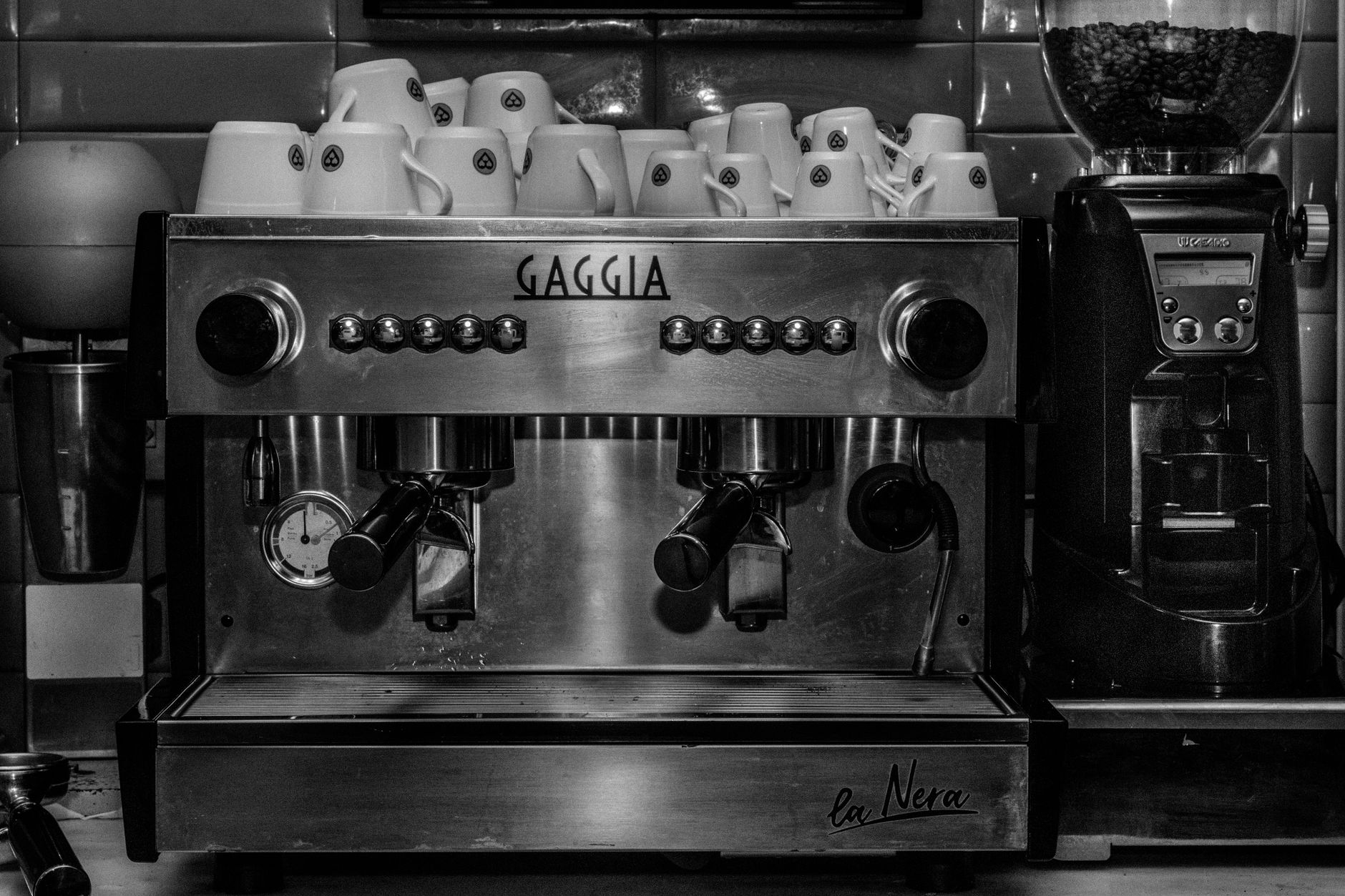 Black and white image of a Gaggia espresso machine in a cozy café.