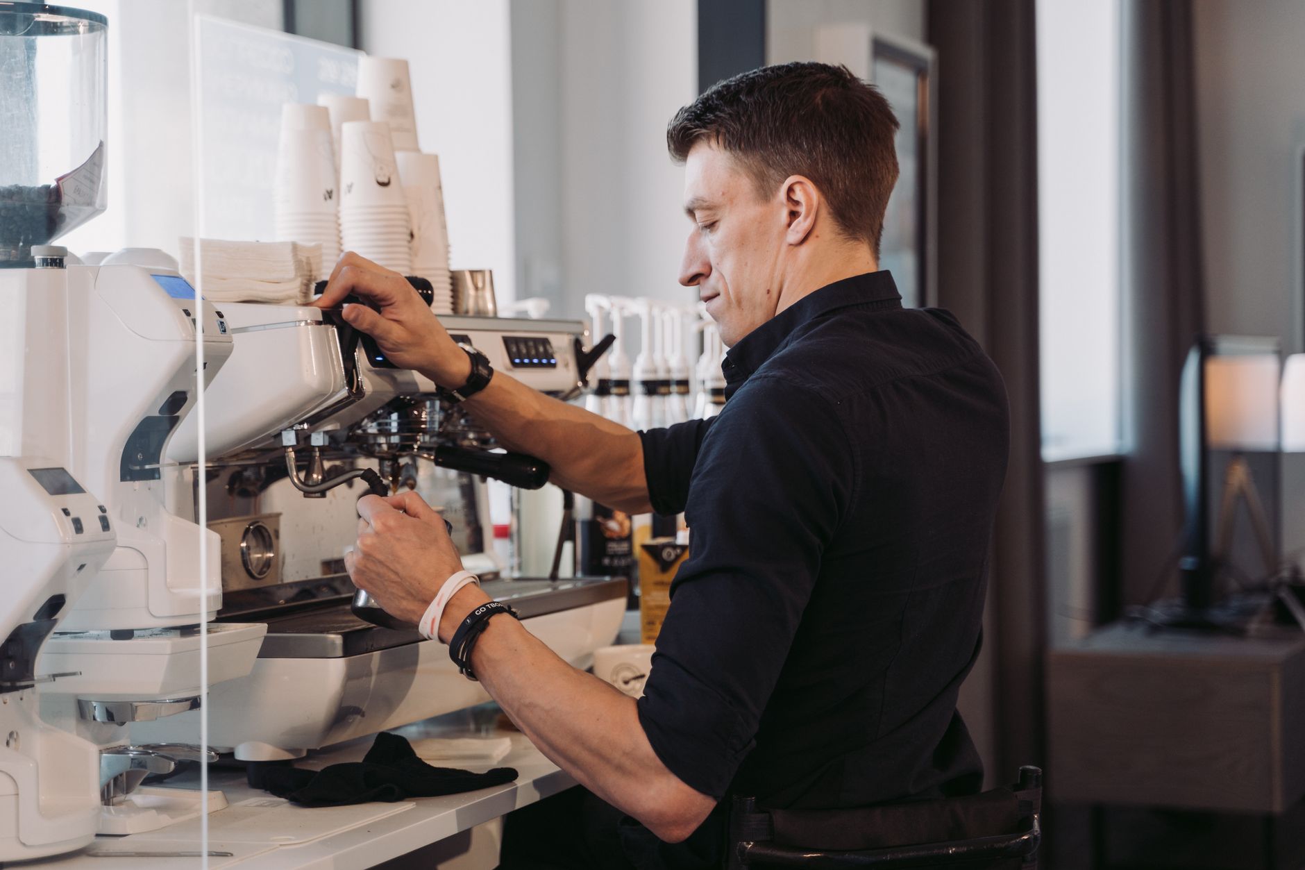 Professional barista station with espresso machine and accessories organized for efficiency