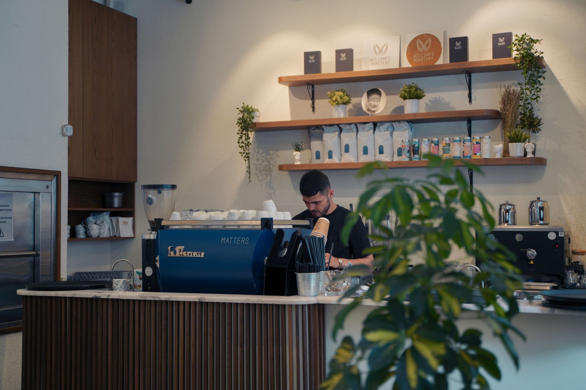 High-tech commercial espresso machine with latte art steaming wand in cafe setting