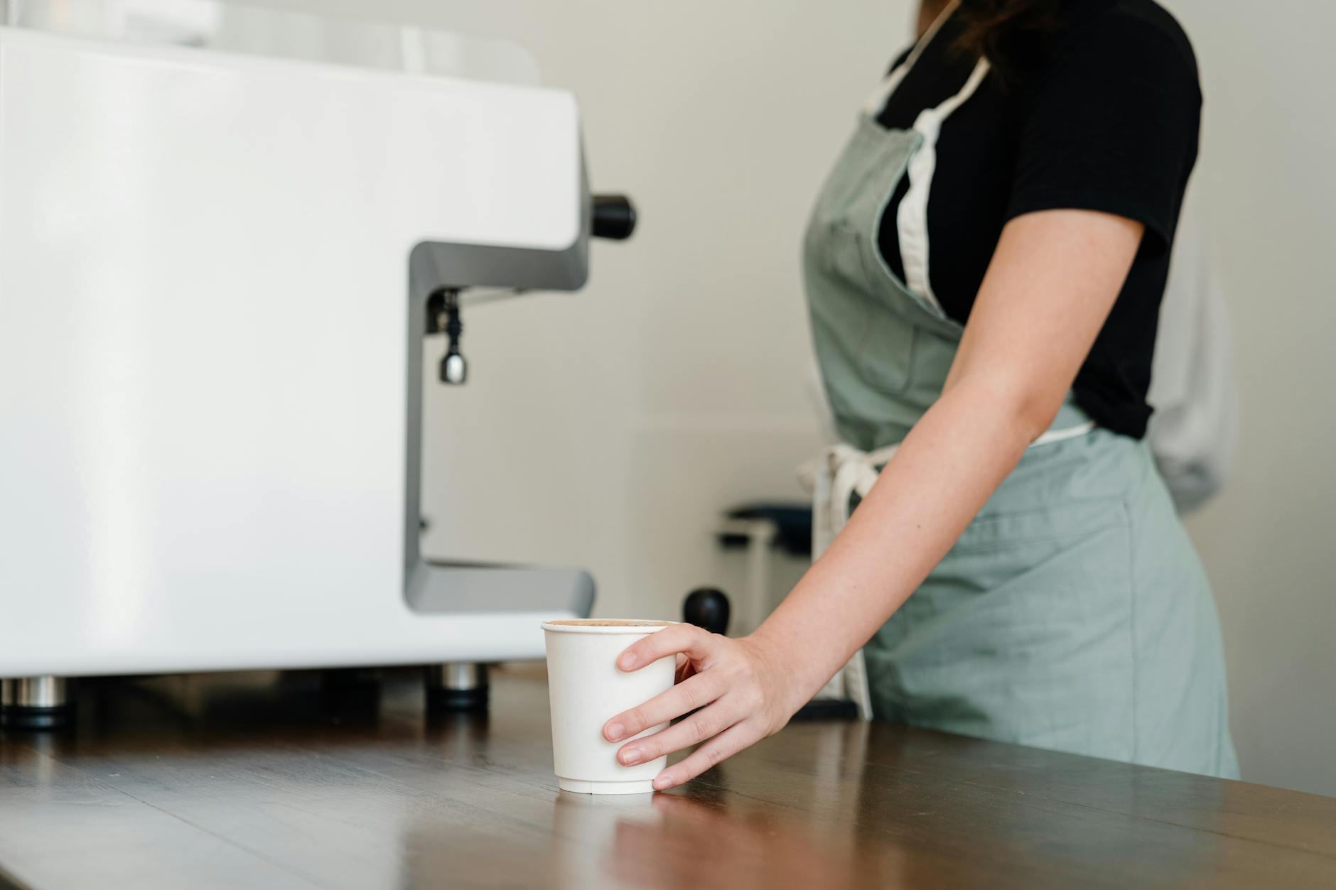 Employees using single-serve coffee machines in office break room