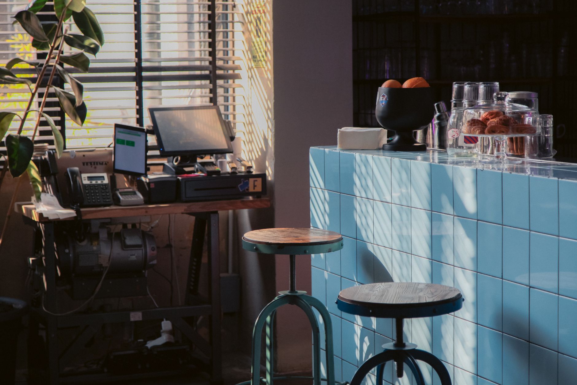 Modern coffee brewer in convenience store with fresh pastries