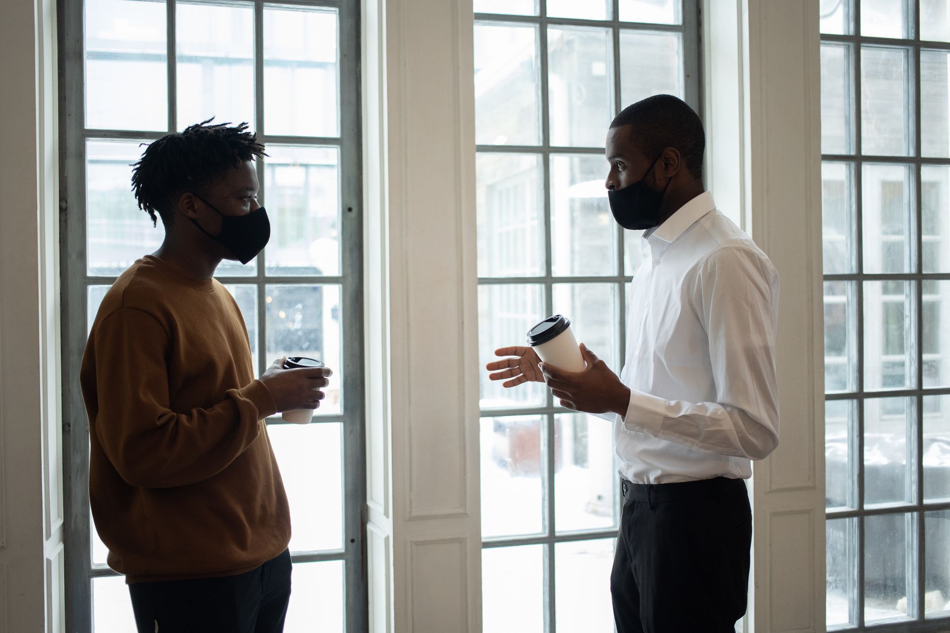Diverse Boston professionals enjoying espresso during office break