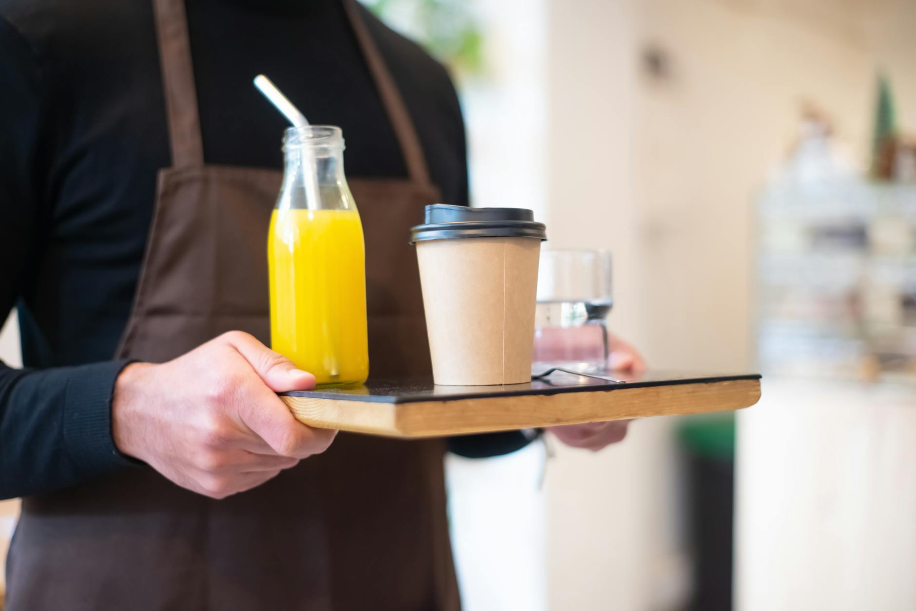 Barista serving coffee from industrial roaster