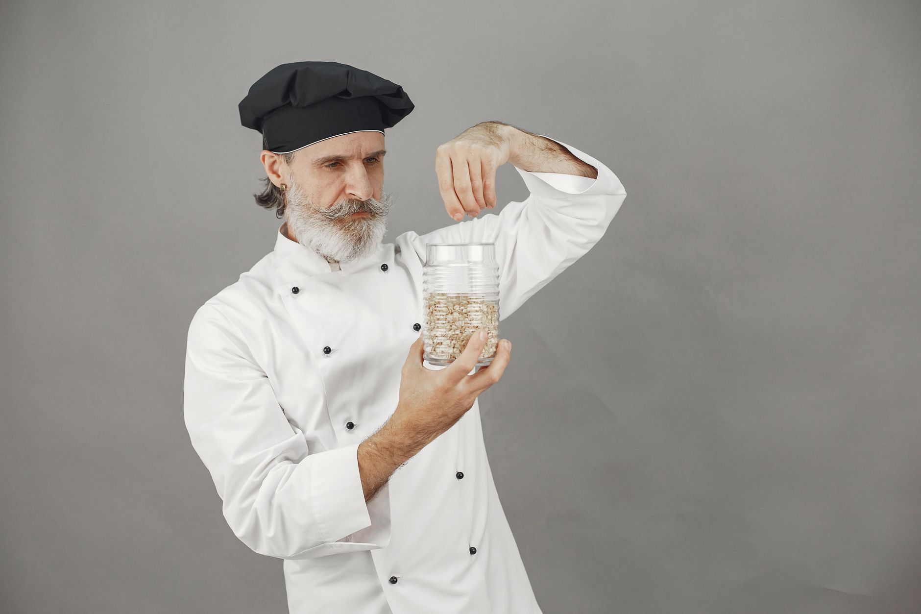 Chef monitoring industrial coffee roaster controls