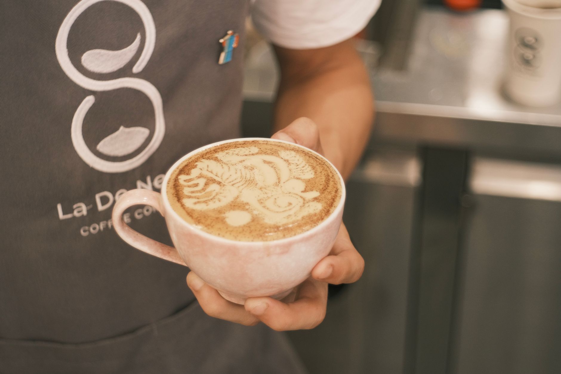 Intricate barista-created tulip design using professional etching tools
