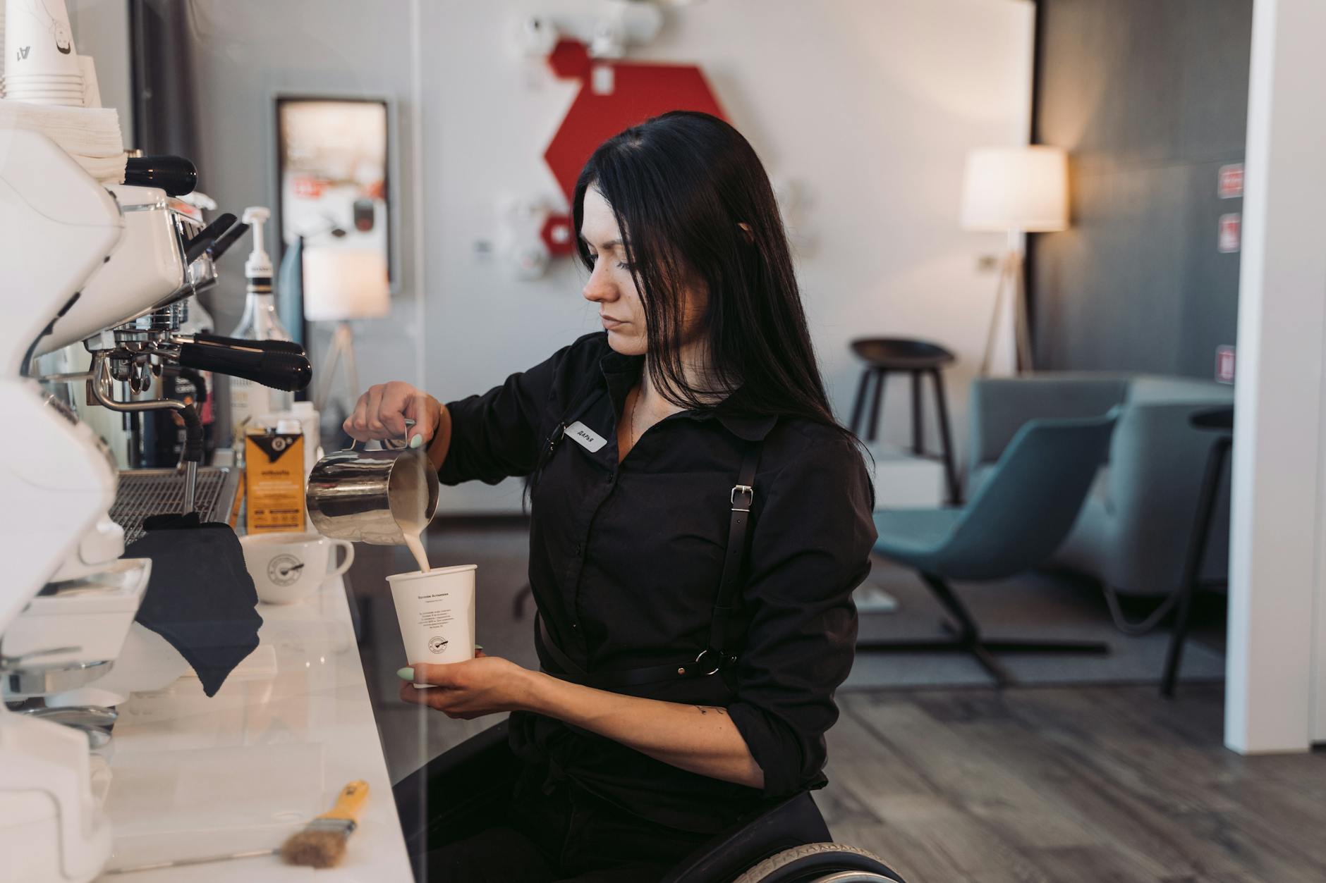 Busy office coffee station with employees pouring drinks