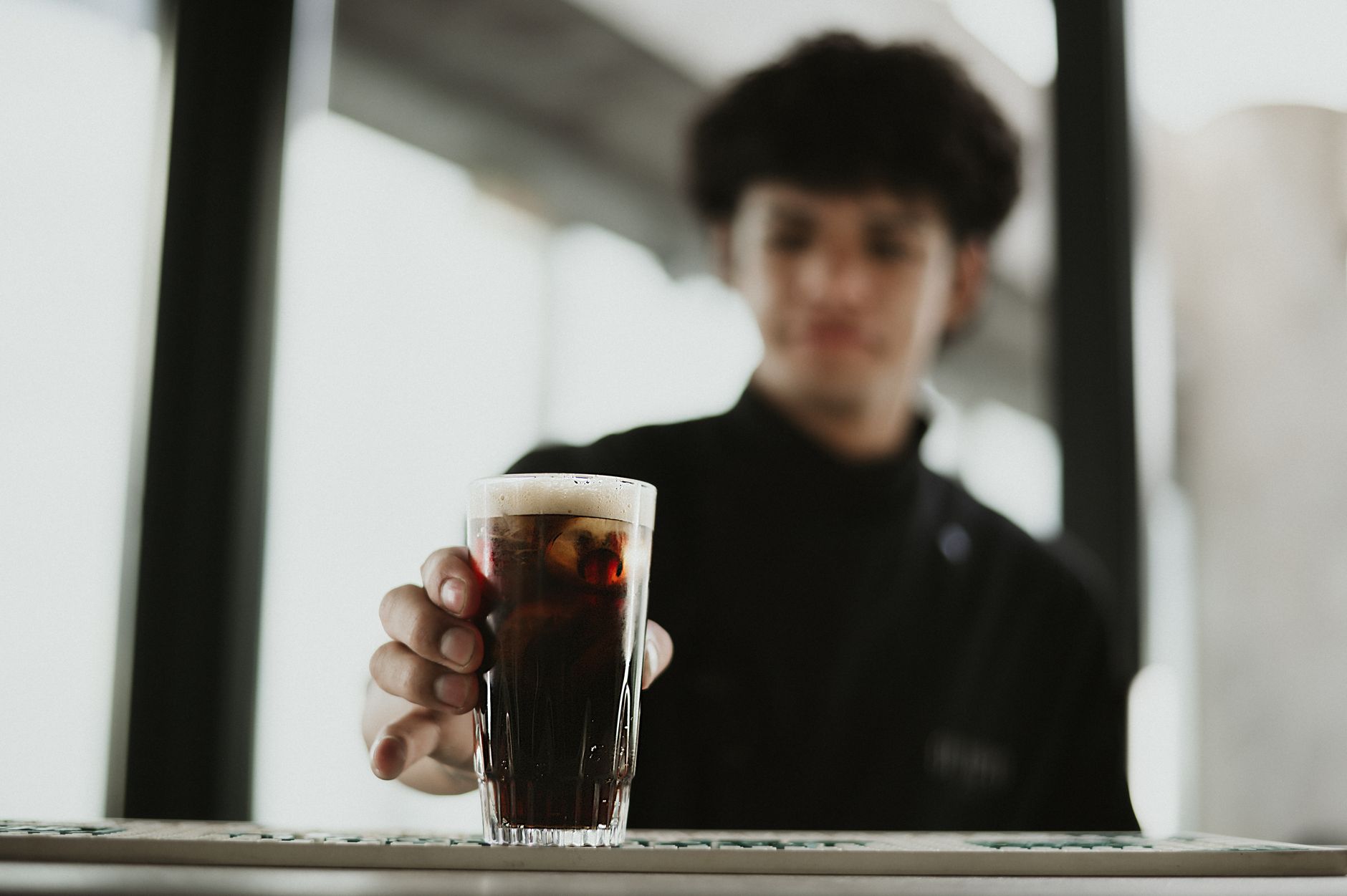 Professional barista serving specialty coffee in a Charleston café
