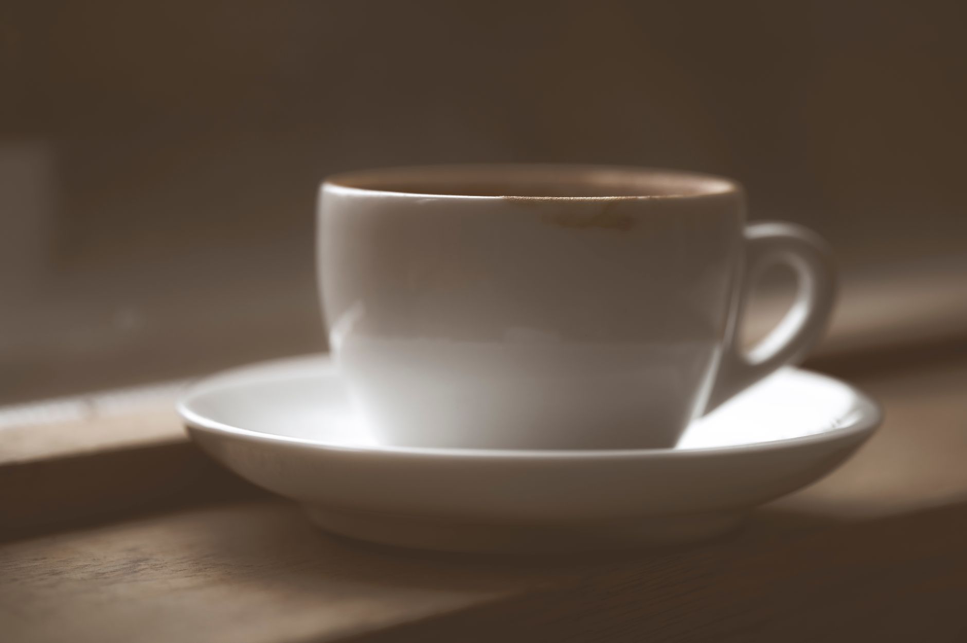 Staff serving coffee to seniors in a bright community room