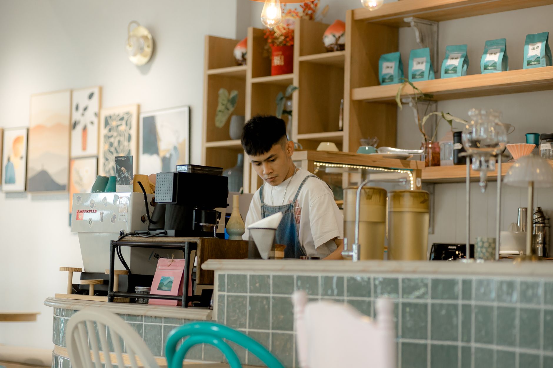 Professional barista using weighted espresso tamper with perfect 90-degree angle