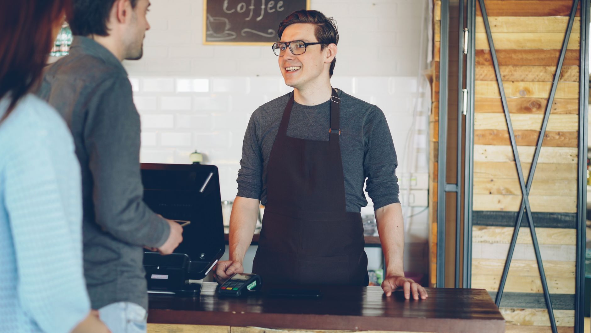 Professional trainer teaching restaurant staff proper coffee techniques