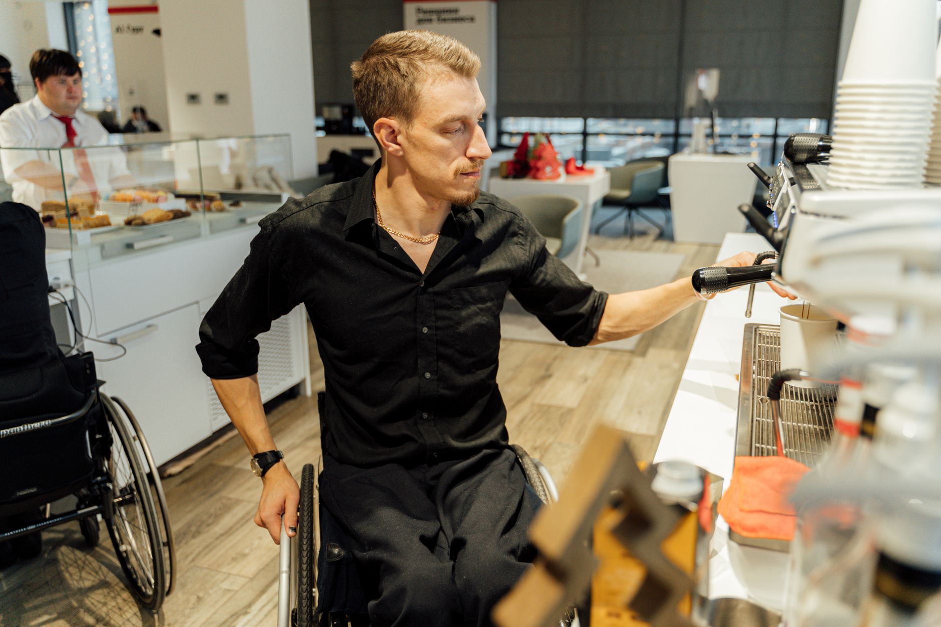 Professional barista operating a bean-to-cup coffee machine in Savannah