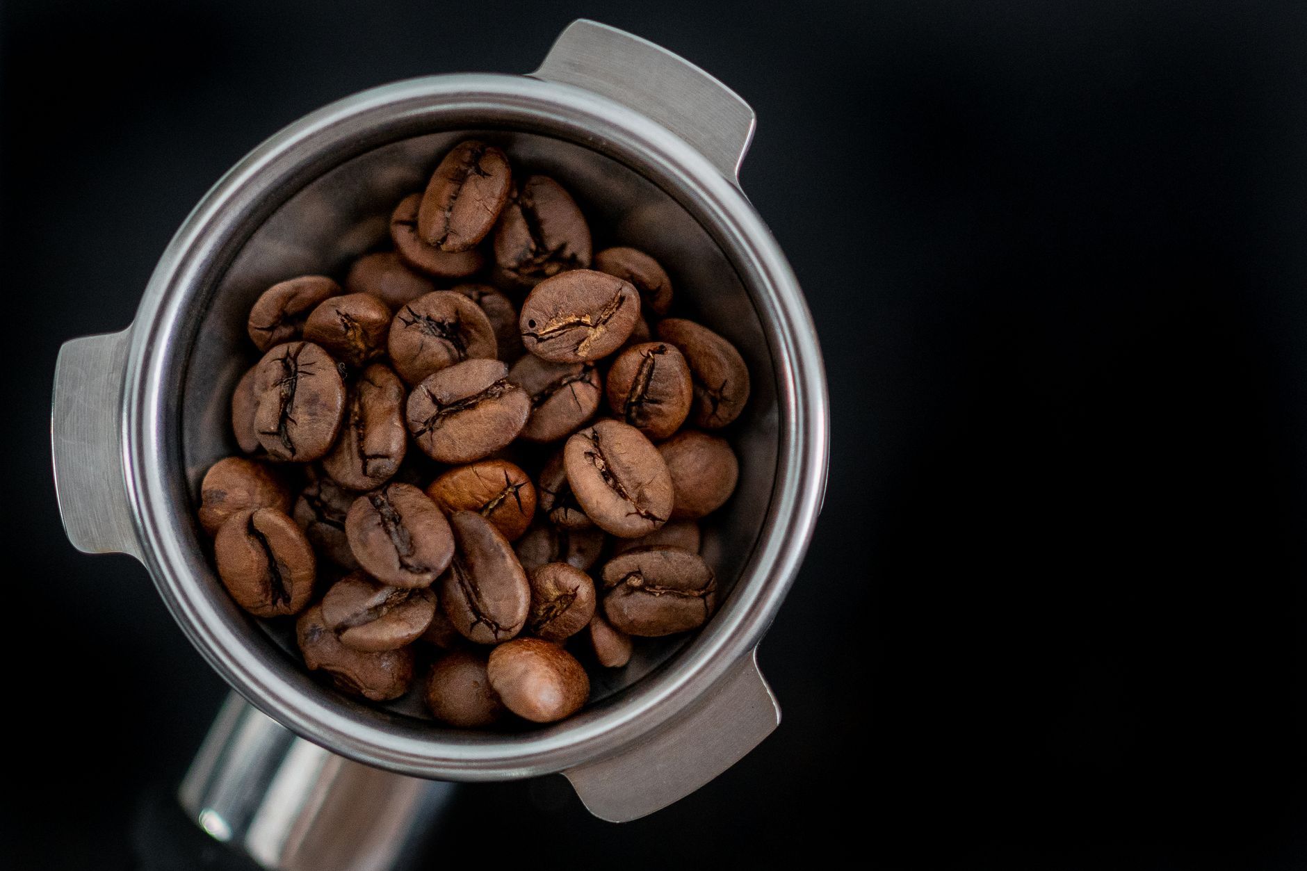 Close-up of perfectly measured medium roast coffee beans being weighed for brewing