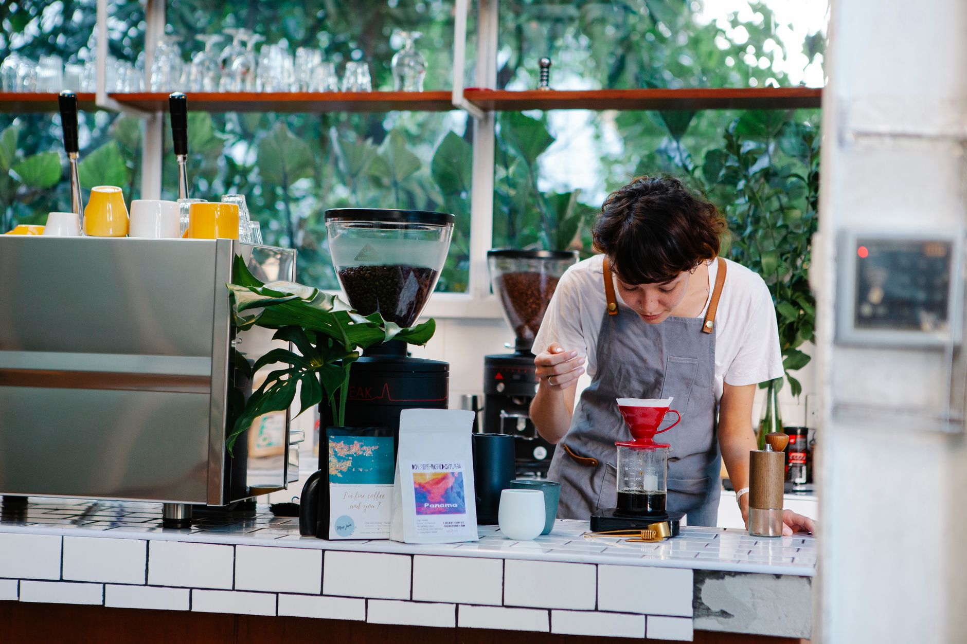 Professional barista using stainless steel dosing funnel on portafilter