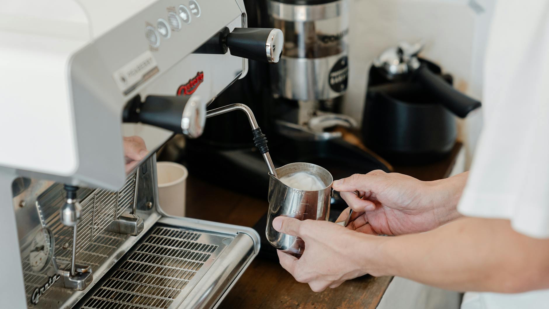 Modern commercial coffee equipment in a busy cafe