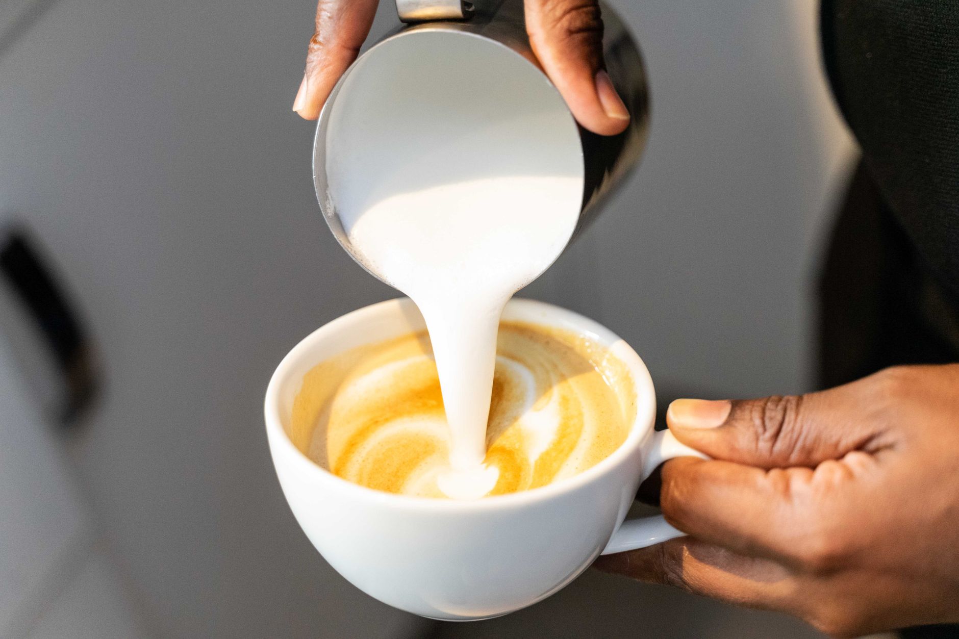 Professional barista crafting latte in a Richmond VA cafe