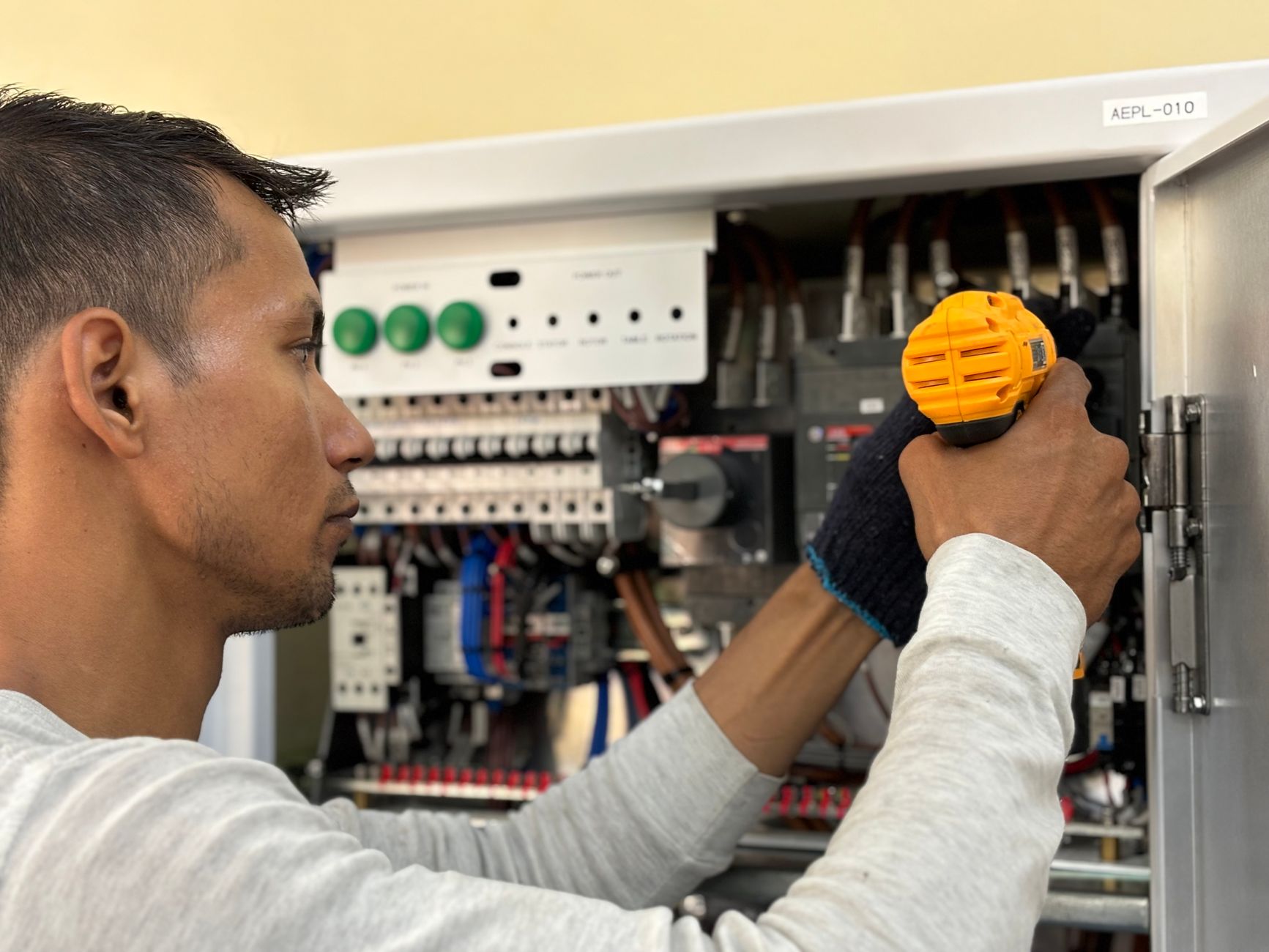 Certified technician performing preventive maintenance on commercial espresso machine